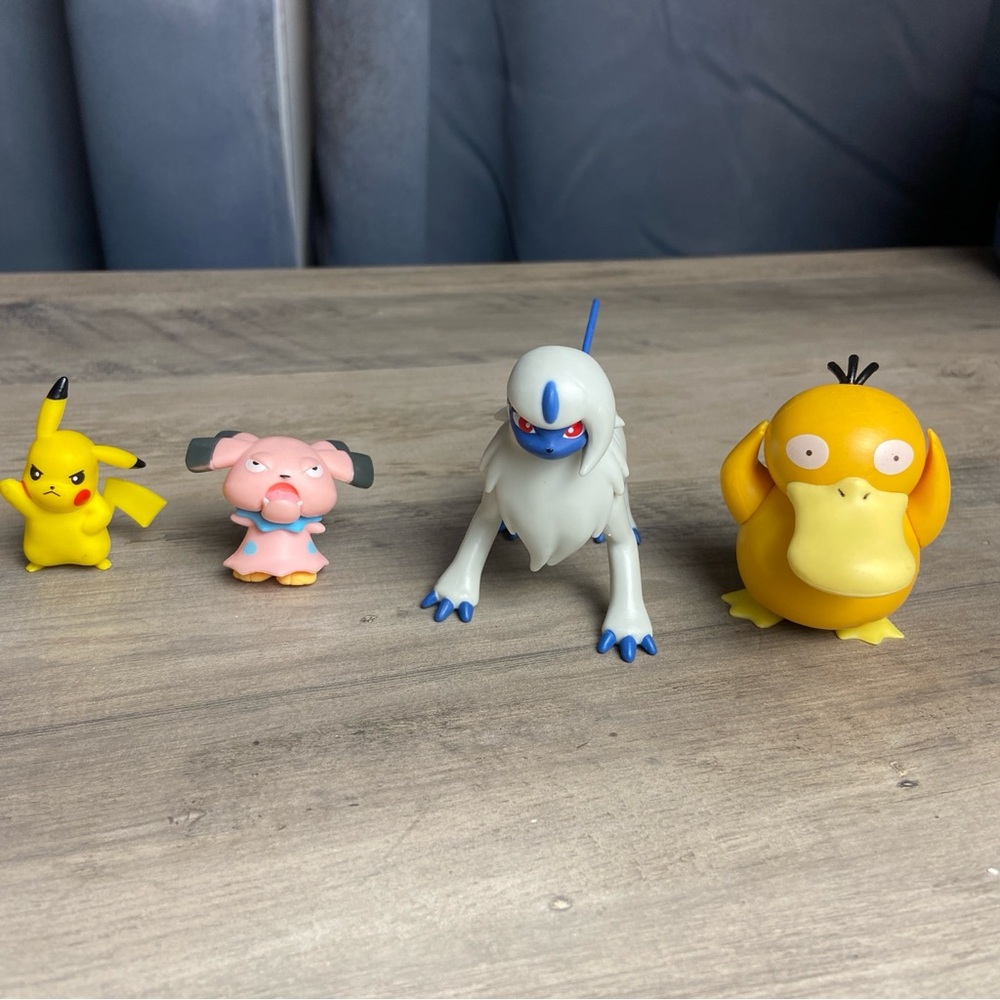 Set of four‎ Pokemon figurines featuring Pikachu, Snubbull, Absol, and Psyduck
